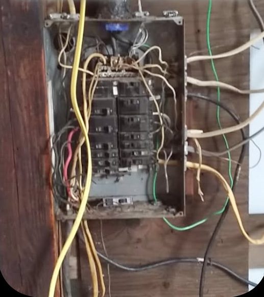 Overloaded and corroded electrical panel before replacement by Mountain City Electric